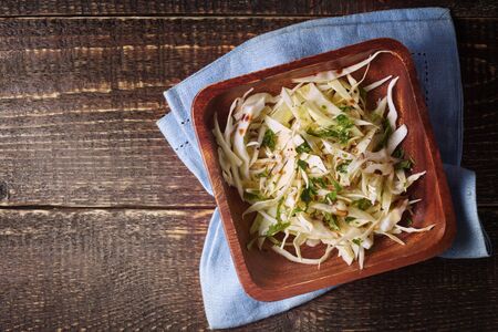 Cabbage salad on the wooden table top viewの写真素材