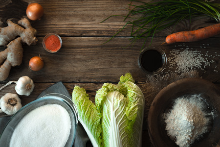Frame with Chinese cabbage and ingredients for kimchi on a wooden table horizontalの写真素材