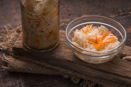 Bank and saucer with sauerkraut on a wooden stand horizontalの写真素材