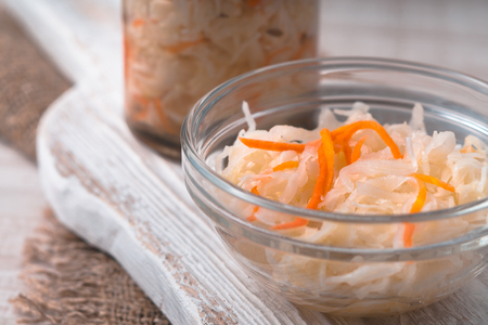 Sauerkraut with carrots in the pot and bowl close-up horizontalの写真素材