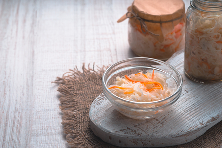 Sauerkraut in glass jars with carrot on the table horizontalの写真素材