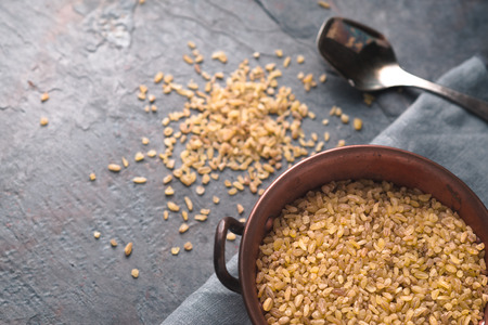 Placer bulgur on a table and in a bowl diagonal horizontalの写真素材