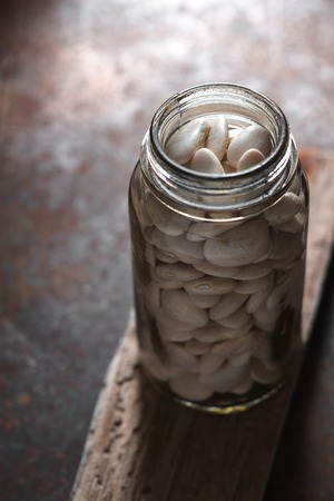 Large white beans in a glass jarの写真素材