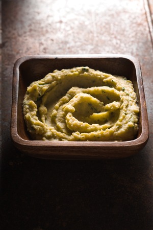 Puree beans in a wooden bowl on the tableの写真素材