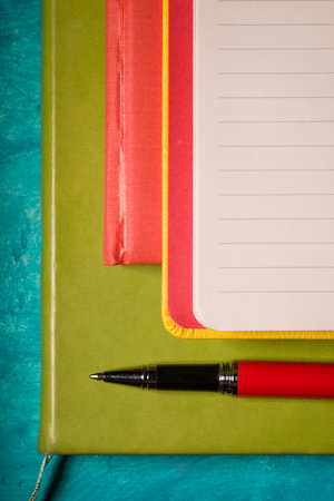 Set of notebook with pen on the cyan backgroundの写真素材