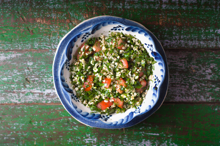 Tabouli salad on the old wooden background top view horizontalの写真素材