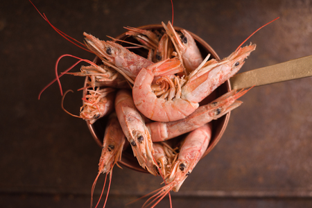 Large shrimps in a saucepan on a metallic background horizontalの写真素材
