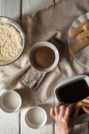 Cooking tiramisu on the white wooden table  top view verticalの写真素材