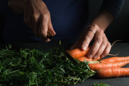 Plant, knife in hand, carrot side viewの写真素材