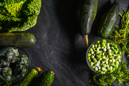 Frame of green vegetables of cucumbers savoy cabbage free spaceの写真素材