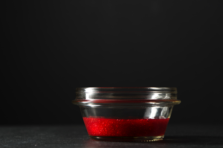 Glass bowl with cranberry sauce on the table side viewの写真素材