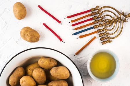 Hanukkah, olive oil and potatoes on a white backgroundの写真素材