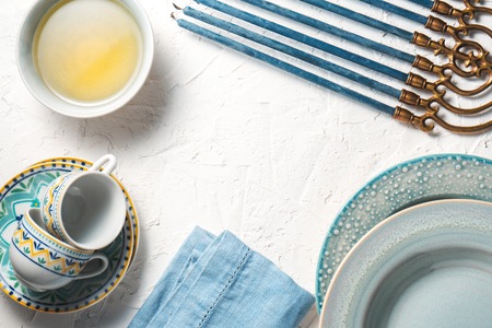 Chanukiah frame, butter in a bowl, plates and cupsの写真素材