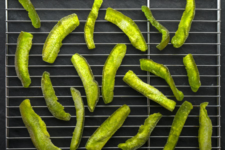 Pieces of green pomelo on the grill for dryingの写真素材