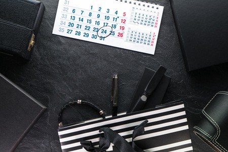 Package with a black bow and with gifts, different boxes, calendarの写真素材