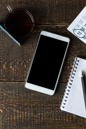 Payment card, phone, notebook and calendar on wooden boardsの写真素材