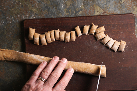 Cutting the dough to produce homemade pasta is a top view.の写真素材