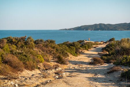 Sea and shadows on the road in Greece horizontalの写真素材