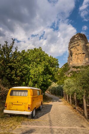Yellow car on cobblestone road in Greece verticalの写真素材