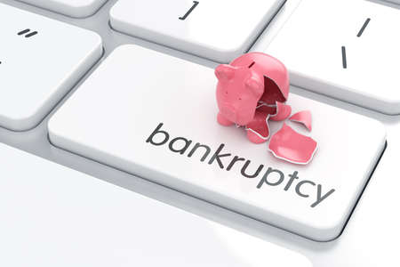 Empty broken piggy bank on the computer keyboard. Crisis concept