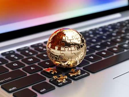3d rendering of a golden spherical jigsaw puzzle with gold segments on the computer keyboardの写真素材