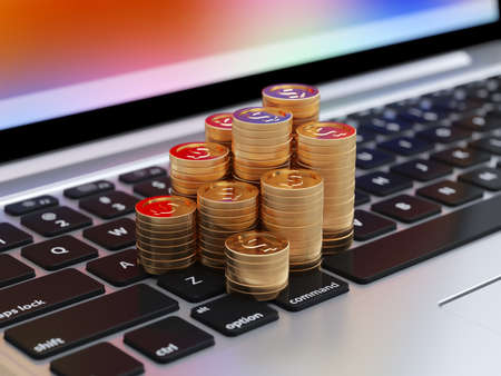 Banking, financial concept. Stack of golden coins on laptop keyboardの写真素材