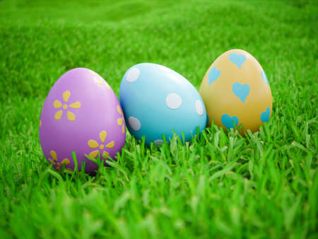 Happy easter! Easter eggs on green grass field background. 3d rendering illustration