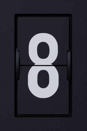Airport mechanical flip board panel digits font. Front view white number character 8 eight on dark background. 3d rendering illustrationの写真素材