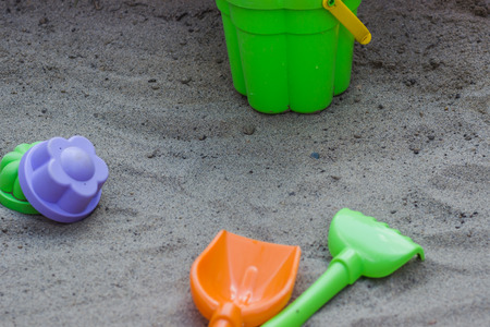 Children's beach toys - buckets, spade and shovel on sand on a sunny dayの写真素材