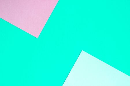 Abstract geometric flat background from colored paper. Green and pink colored paper, a template for adding text.の写真素材