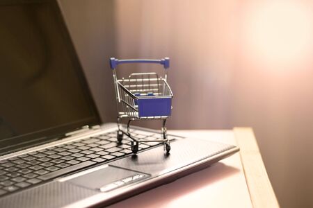 Shopping basket on laptop keyboard. Online shopping, home shopping.の写真素材