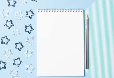 Female workspace with open notebook and pencil on a white table. Work from home, blogger workplace.の写真素材