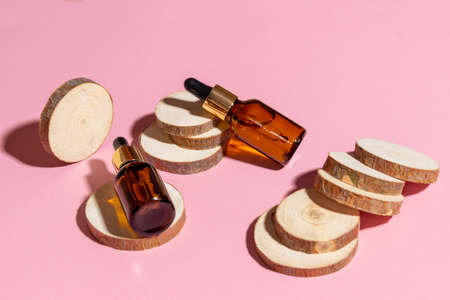 Natural cosmetics in glass bottles with a dropper on a beige background. The concept of natural...