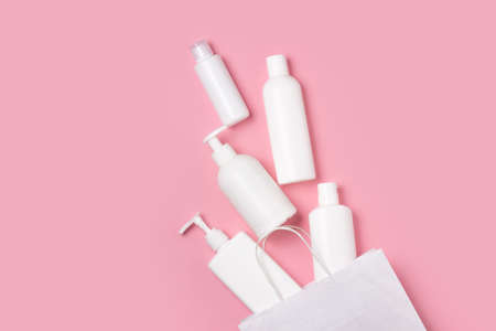White cosmetic jars on a pink background. Cosmetics for skin care