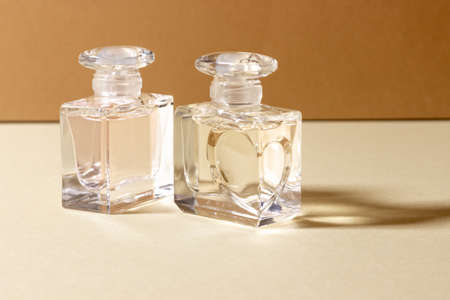 Glass perfume bottles in bright sunlight with harsh shadows.