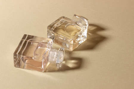 Glass perfume bottles in bright sunlight with harsh shadows.