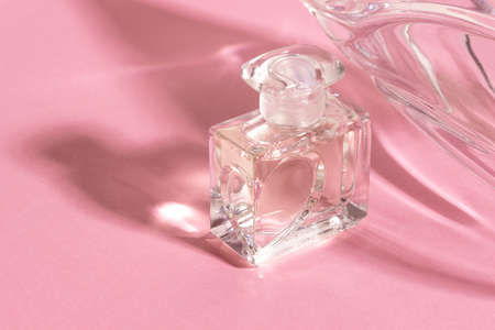 Glass perfume bottles in bright sunlight with harsh shadows.の写真素材