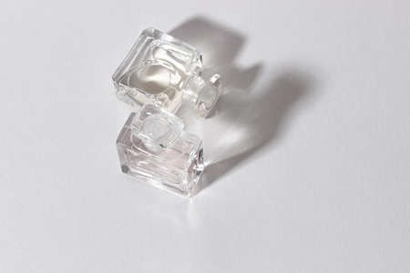 Glass perfume bottles in bright sunlight with harsh shadows.の写真素材