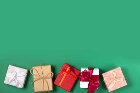 Bright gift boxes, on a green background. Top view, holiday and Christmas concept. flatly,