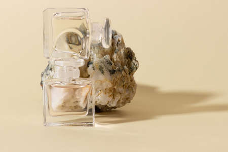 Glass perfume bottles in bright sunlight with harsh shadows.の写真素材