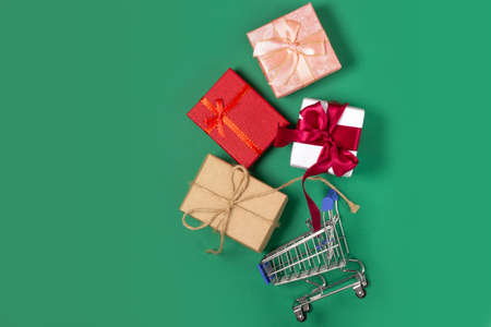 Gift boxes lie in a shopping basket. Gift shopping concept, online storeの写真素材