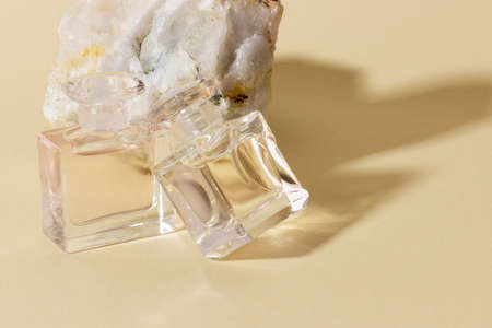 Glass perfume bottles in bright sunlight with harsh shadows.の写真素材