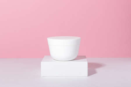 Natural cosmetic. Jar with cream or face mask. White container with women's skin care product on the...