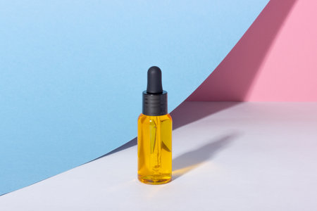 Serum bottle with dropper with shadows on the background. Skincare beauty spa product and pipette