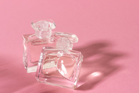 Glass perfume bottles in bright sunlight with harsh shadows.の写真素材