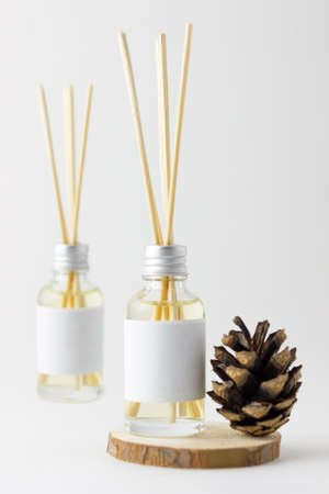 Home incense sticks with natural pine scent. Cones and spruce frame with aroma diffuser. Eco-friendly home fragrance conceptの写真素材