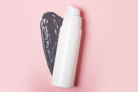 White cosmetic jar, on the background of smeared cream or cosmetic face mask. Purifying and moisturizing clay mask. Top view, flat layの写真素材