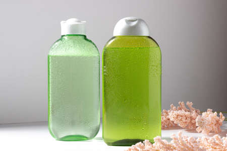 Facial cleanser bottle. Lotion or micellar water for face cleansing. Liquid cosmetic product in green packaging. Natural cosmetics conceptの写真素材