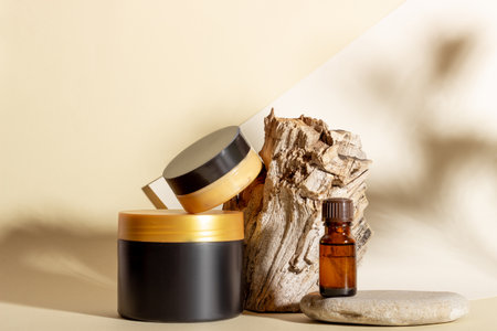 A set of cosmetic products next to a log and hard shadows on a beige background. Natural organic cosmeticsの写真素材