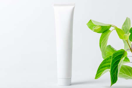 Cosmetic cream for moisturizing and cleansing the face. White bottle with empty spaceの写真素材